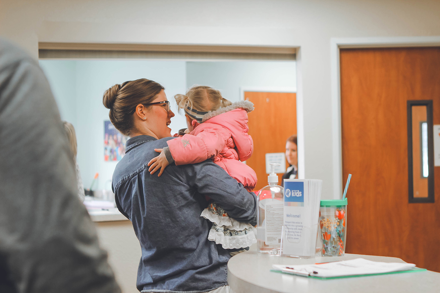 Parent holding child in doctor's office