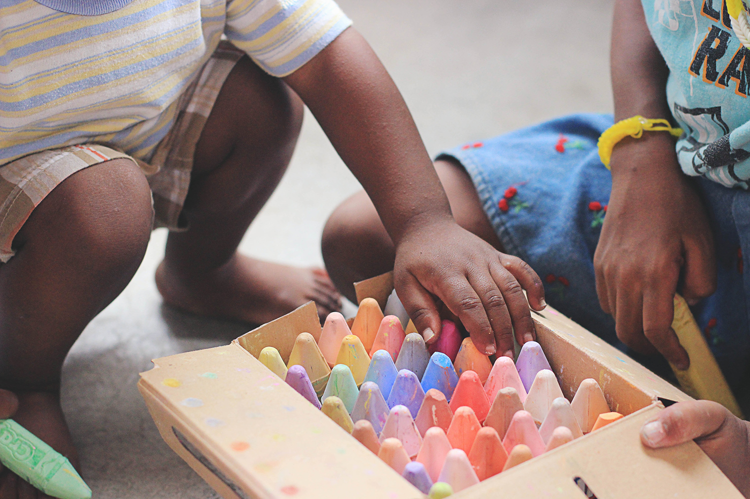 Young children playing with chalk